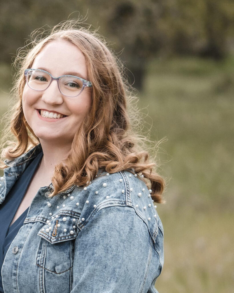 Head shot photo of young woman with glasses